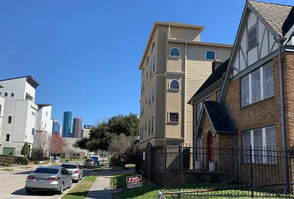 a couple of cars parked in front of buildings