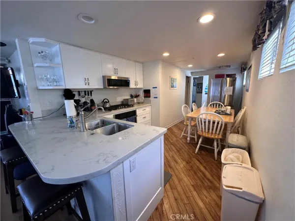 a kitchen with a dining table chairs and view living room