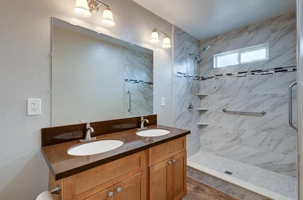 a bathroom with a sink double vanity and a mirror