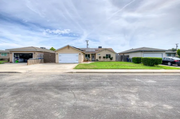 a view of house with outdoor space and swimming pool