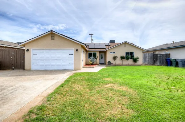 a view of a house with a yard and garage