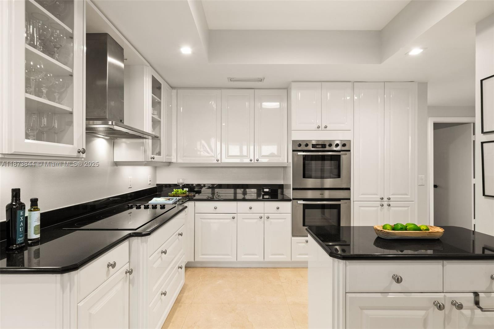 21200 Point Place, Unit 1102 Aventura, FL 33180 - Photo 11 of 41 a kitchen with granite countertop a sink a stove and cabinets