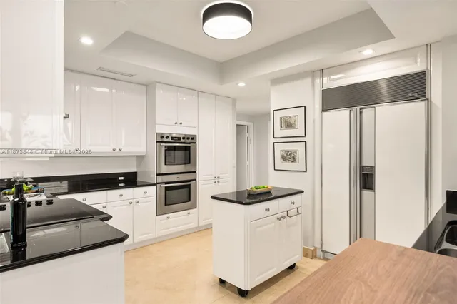 a kitchen with stainless steel appliances a stove microwave and a refrigerator