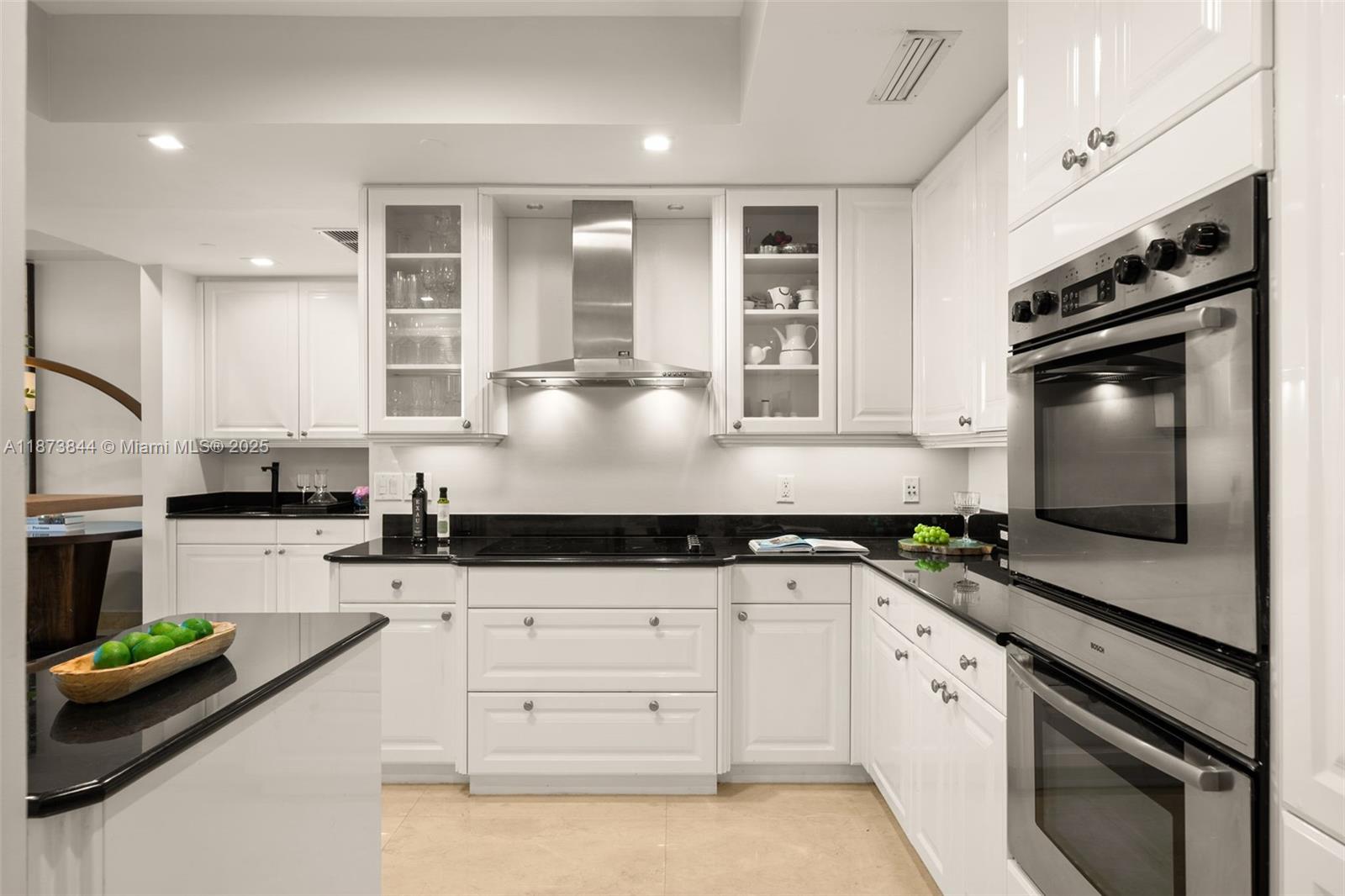 21200 Point Place, Unit 1102 Aventura, FL 33180 - Photo 15 of 41 a kitchen with granite countertop a sink stainless steel appliances and cabinets