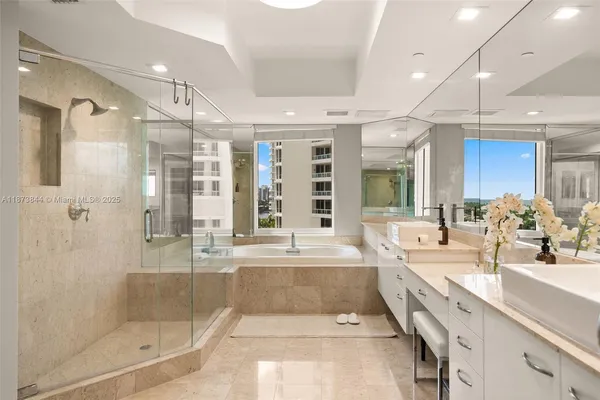 a large bathroom with a large tub shower sink and mirror