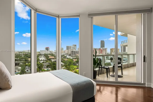 a bedroom with a large window and a table