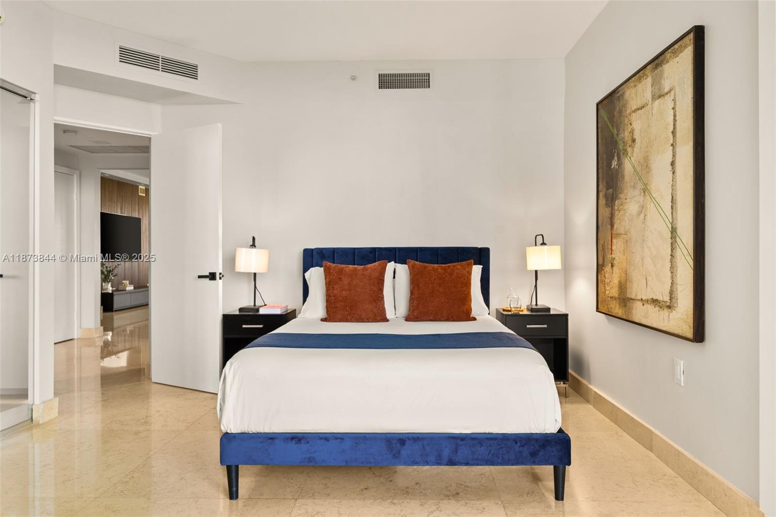 21200 Point Place, Unit 1102 Aventura, FL 33180 - Photo 28 of 41 a bedroom with a bed and a night stand