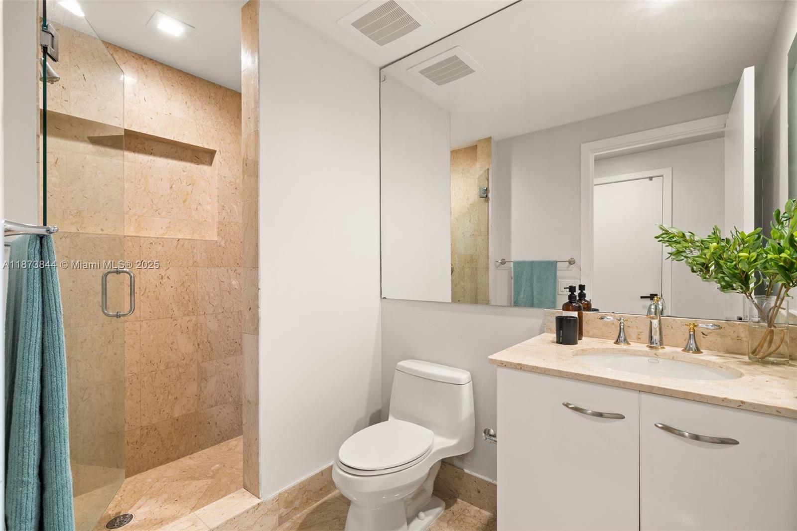 21200 Point Place, Unit 1102 Aventura, FL 33180 - Photo 29 of 41 a bathroom with a granite countertop sink toilet and shower