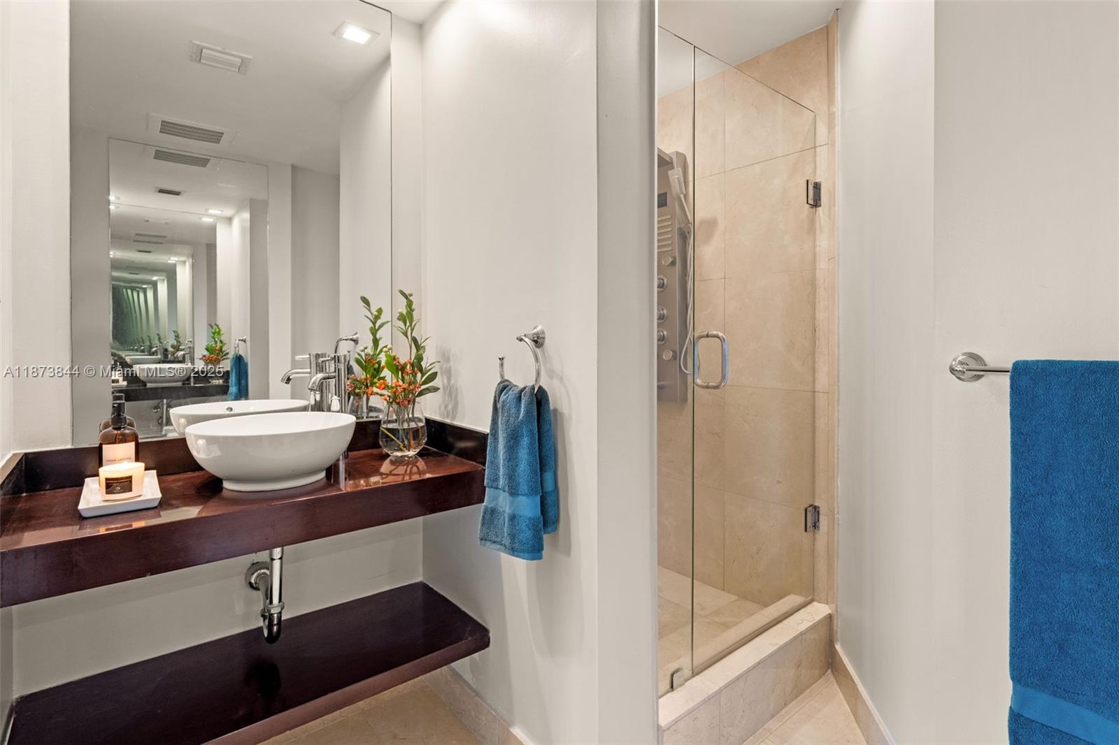 21200 Point Place, Unit 1102 Aventura, FL 33180 - Photo 30 of 41 a view of a bathroom with a sink and mirror