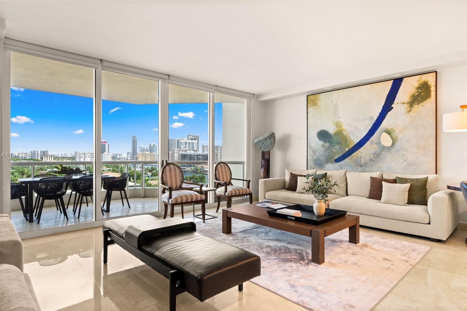 21200 Point Place, Unit 1102 Aventura, FL 33180 - Photo 5 of 41 a living room with furniture and a large window