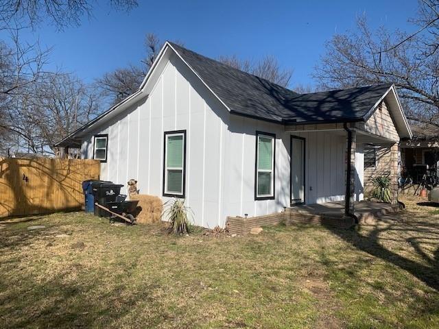 511 East Washington Street Denison, TX 75021 - Photo 9 of 12 View of side of property featuring board and batten siding and covered porch