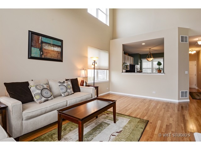 227 Grand Ridge Road, Unit 227 St. Charles, IL 60175 - Photo 3 of 10 a living room with furniture and a wooden floor
