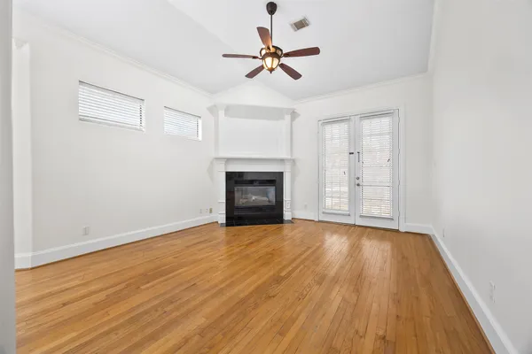 wooden floor in an empty room with a fireplace