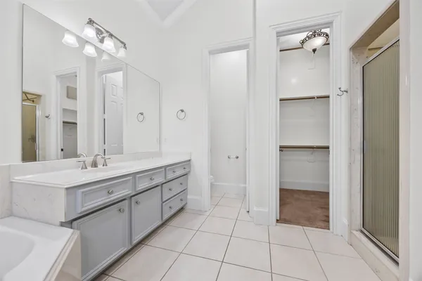 a bathroom with a double vanity sink a mirror and a shower