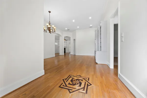 a view of a room with wooden floor staircase and a kitchen