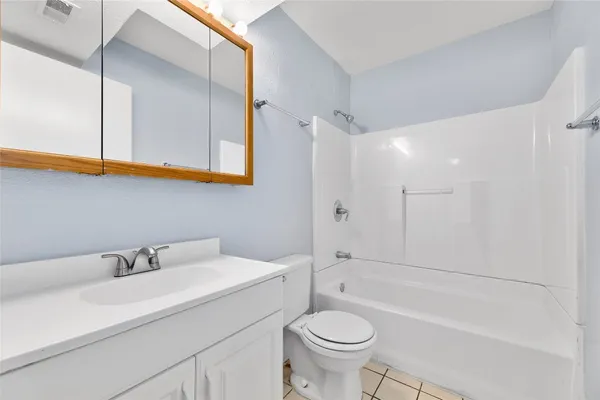a bathroom with a sink a toilet and a bathtub