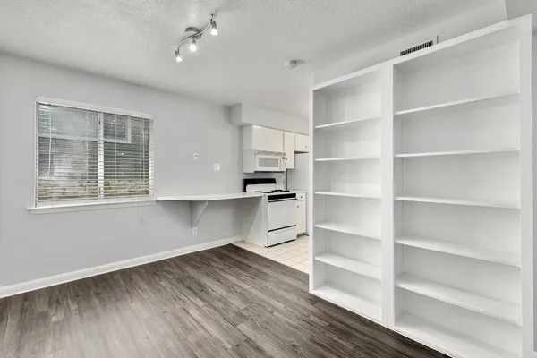 a view of cabinets and wooden floor in a room