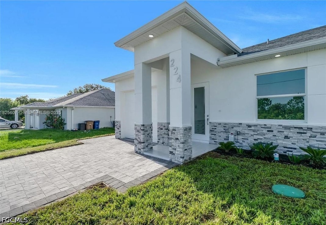 222 Pullman Street Lehigh Acres, FL 33974 - Photo 7 of 9 a front view of house with a garden