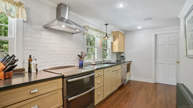 a kitchen with stainless steel appliances a sink and cabinets