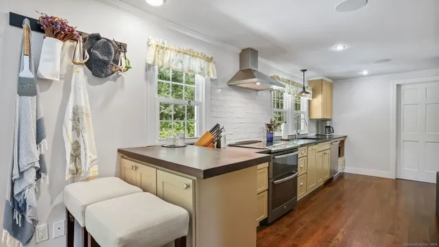 a kitchen with a sink appliances and cabinets