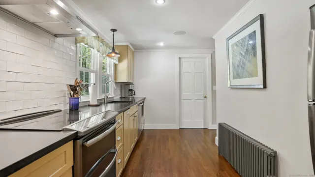 a kitchen with a sink stove and cabinets