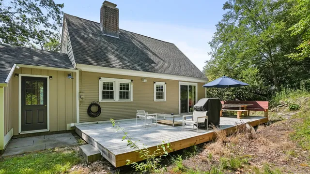 a view of backyard of house with seating space