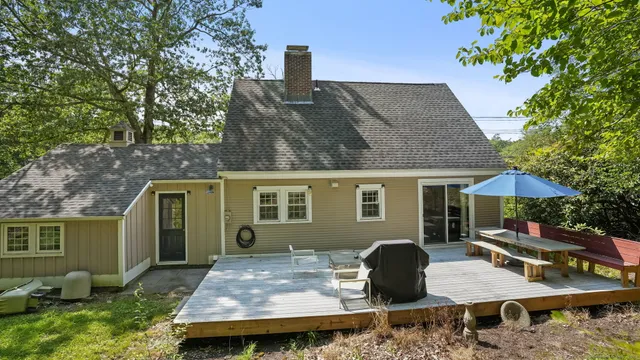 a view of a backyard with furniture and a garden