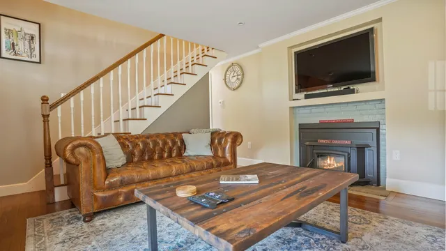a living room with furniture a flat screen tv and a fireplace