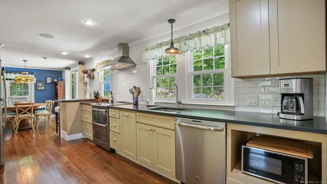 a kitchen with appliances cabinets and a chair