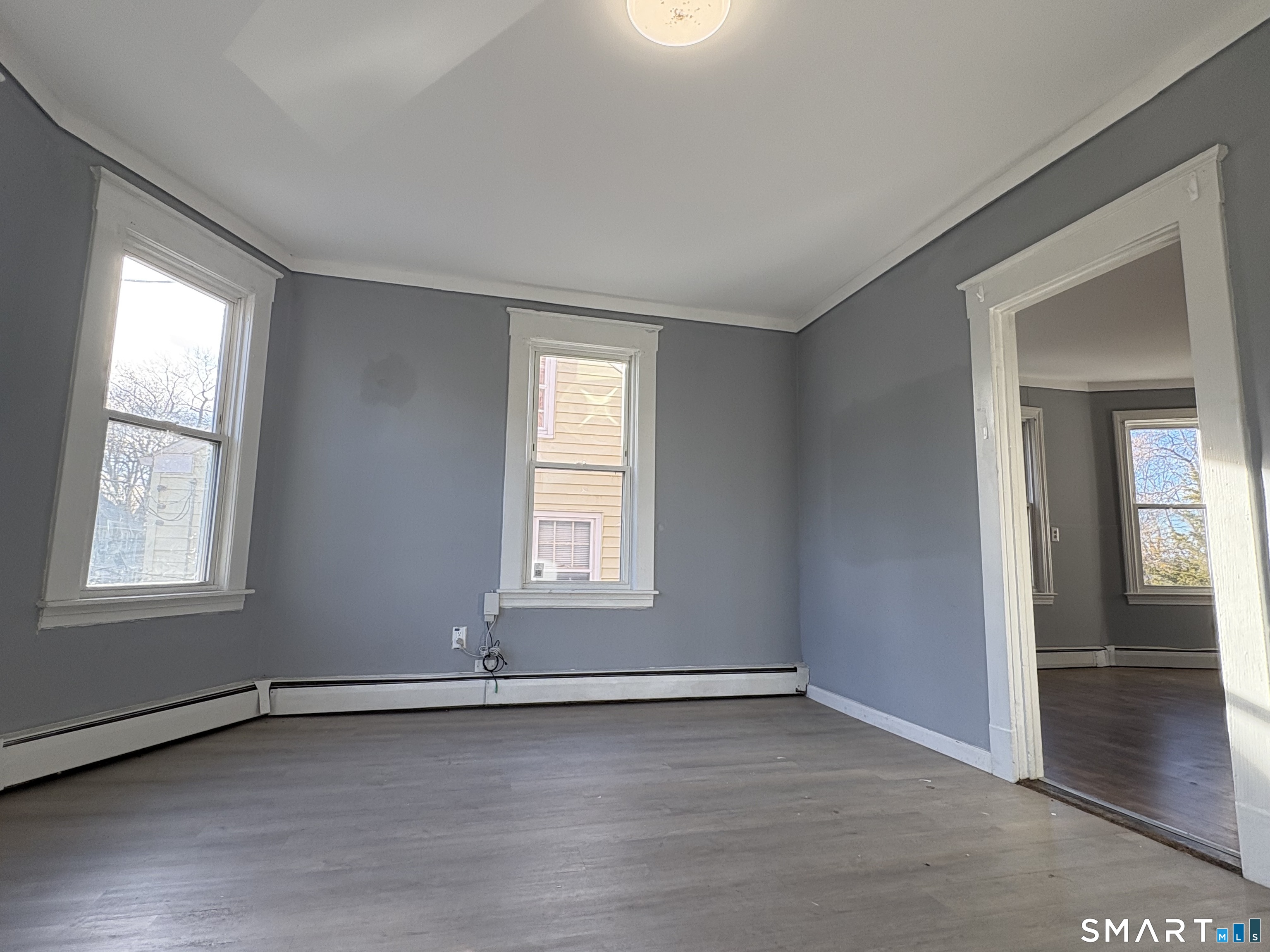3 Omo Street, Unit 2 Middletown, CT 06457 - Photo 2 of 12 an empty room with wooden floor and windows