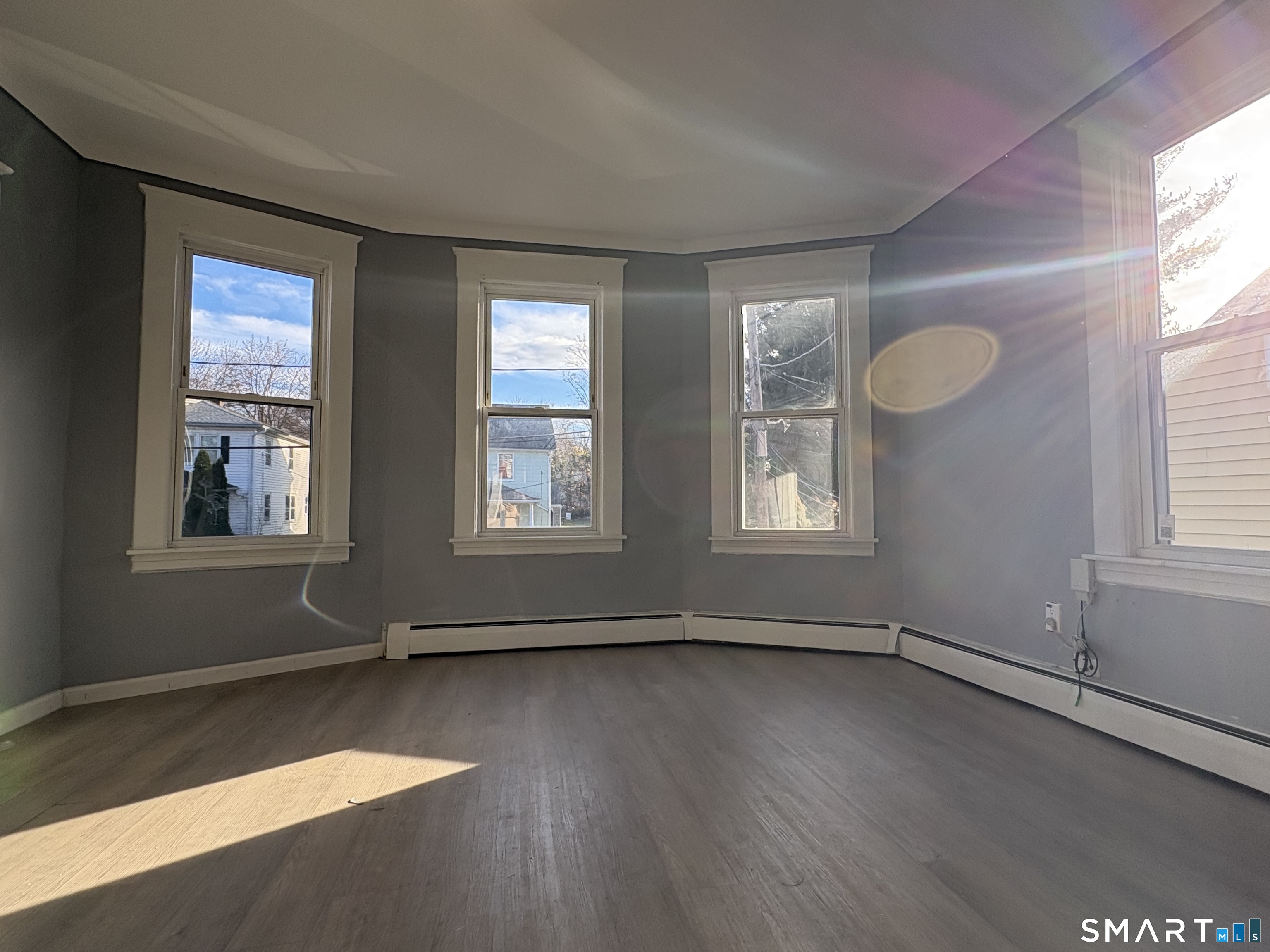 3 Omo Street, Unit 2 Middletown, CT 06457 - Photo 3 of 12 an empty room with wooden floor and windows