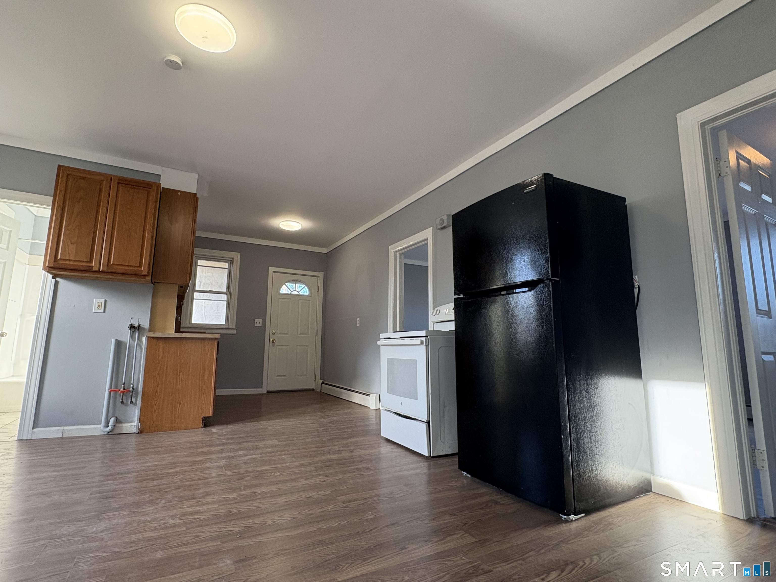 3 Omo Street, Unit 2 Middletown, CT 06457 - Photo 4 of 12 a kitchen with a refrigerator and a stove top oven