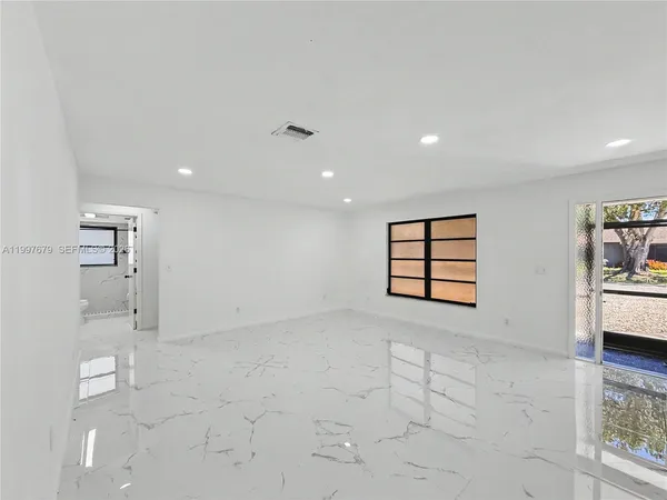 a view of an empty room with a window