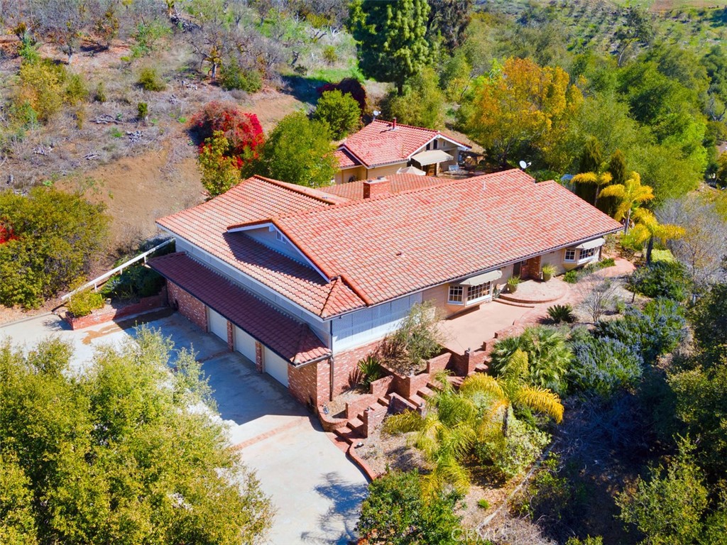 an aerial view of a house with a yard and garden