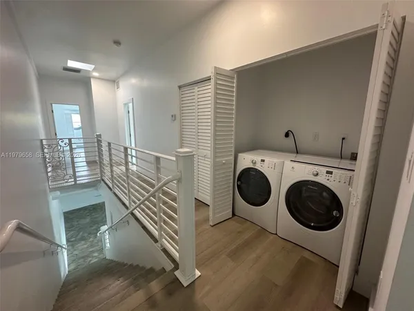 a view of a hallway with washer and dryer