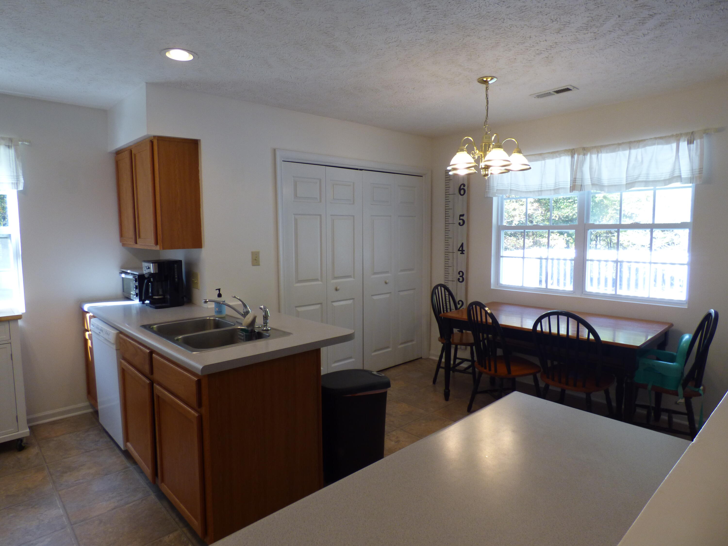 110 Little Cabin Road Northeast Floyd, VA 24091 - Photo 22 of 32 a kitchen with a stove a sink a table and chairs
