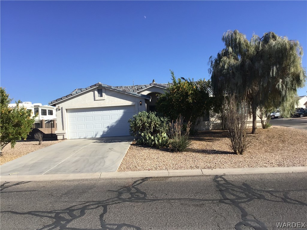 2204 Jamie Road Fort Mohave, AZ 86426 - Photo 1 of 22 a front view of a house with a yard and garage