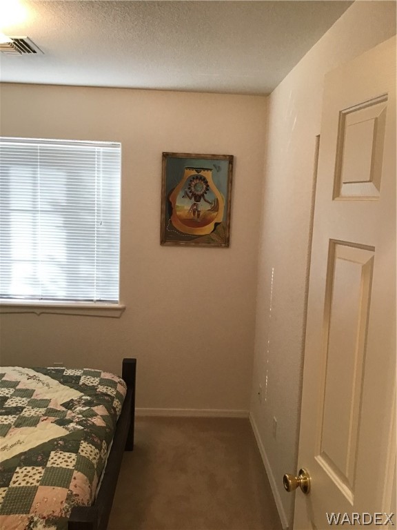 2204 Jamie Road Fort Mohave, AZ 86426 - Photo 13 of 22 a bed sitting in a bedroom next to a window
