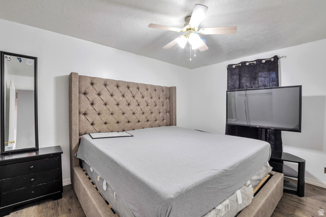 1057 North 700 West Clinton, UT 84015 - Photo 7 of 15 Bedroom with a textured ceiling, ceiling fan, and wood finished floors