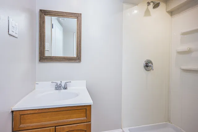 a bathroom with a sink mirror and vanity