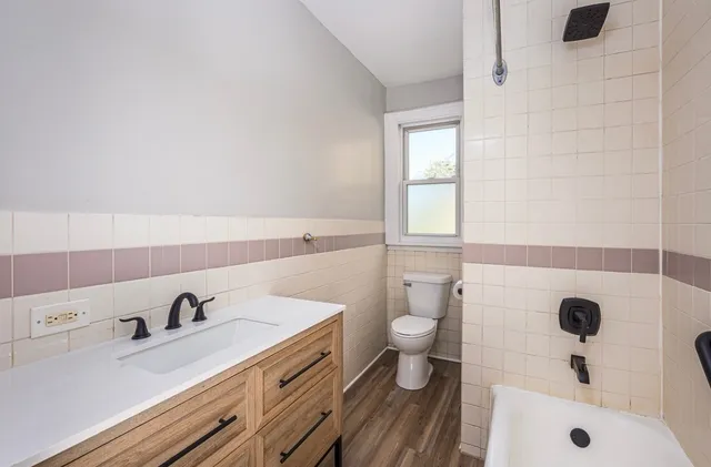 a bathroom with a sink a toilet and a tub