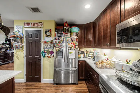 a kitchen with refrigerator and cabinets