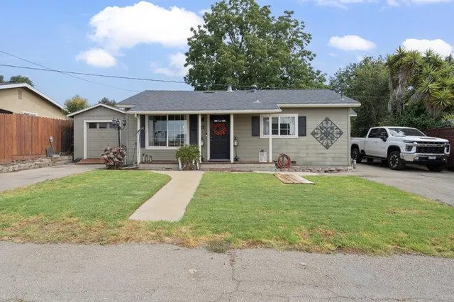 a house view with swimming pool and garden