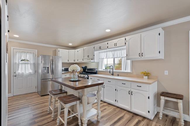 22 Heiner Road Watsonville, CA 95076 - Photo 15 of 51 a kitchen with white cabinets and stainless steel appliances