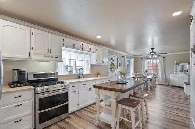 a kitchen with cabinets appliances a sink and a counter top