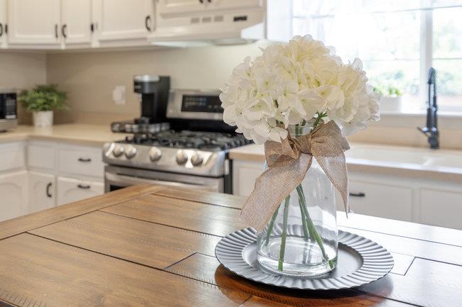 22 Heiner Road Watsonville, CA 95076 - Photo 21 of 51 a kitchen with a stove and a white wooden cabinets