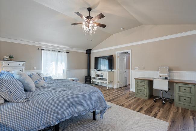 22 Heiner Road Watsonville, CA 95076 - Photo 37 of 51 a spacious bedroom with a bed and a chandelier