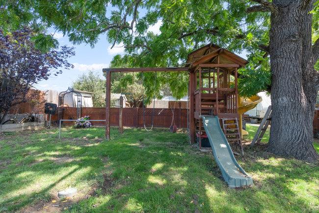 22 Heiner Road Watsonville, CA 95076 - Photo 45 of 51 a view of a backyard with a barbeque grill and a large tree