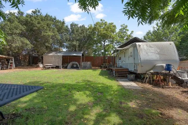 a front view of house with yard and trees