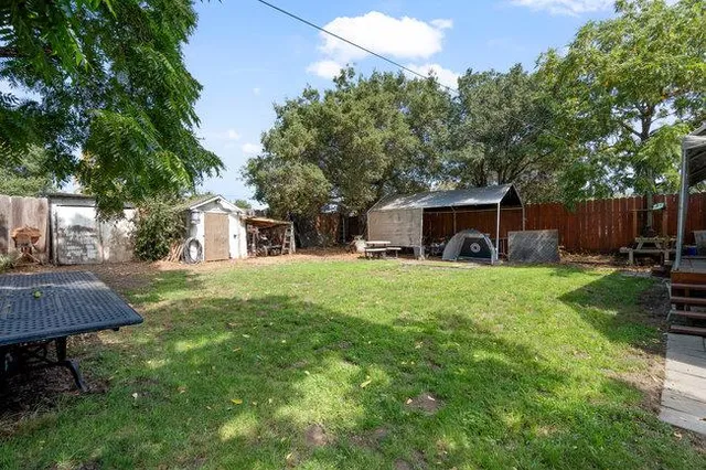 a view of a house with backyard and sitting area